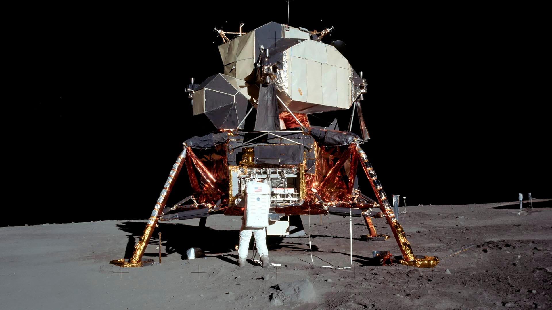 Buzz Aldrin takes the seismometer