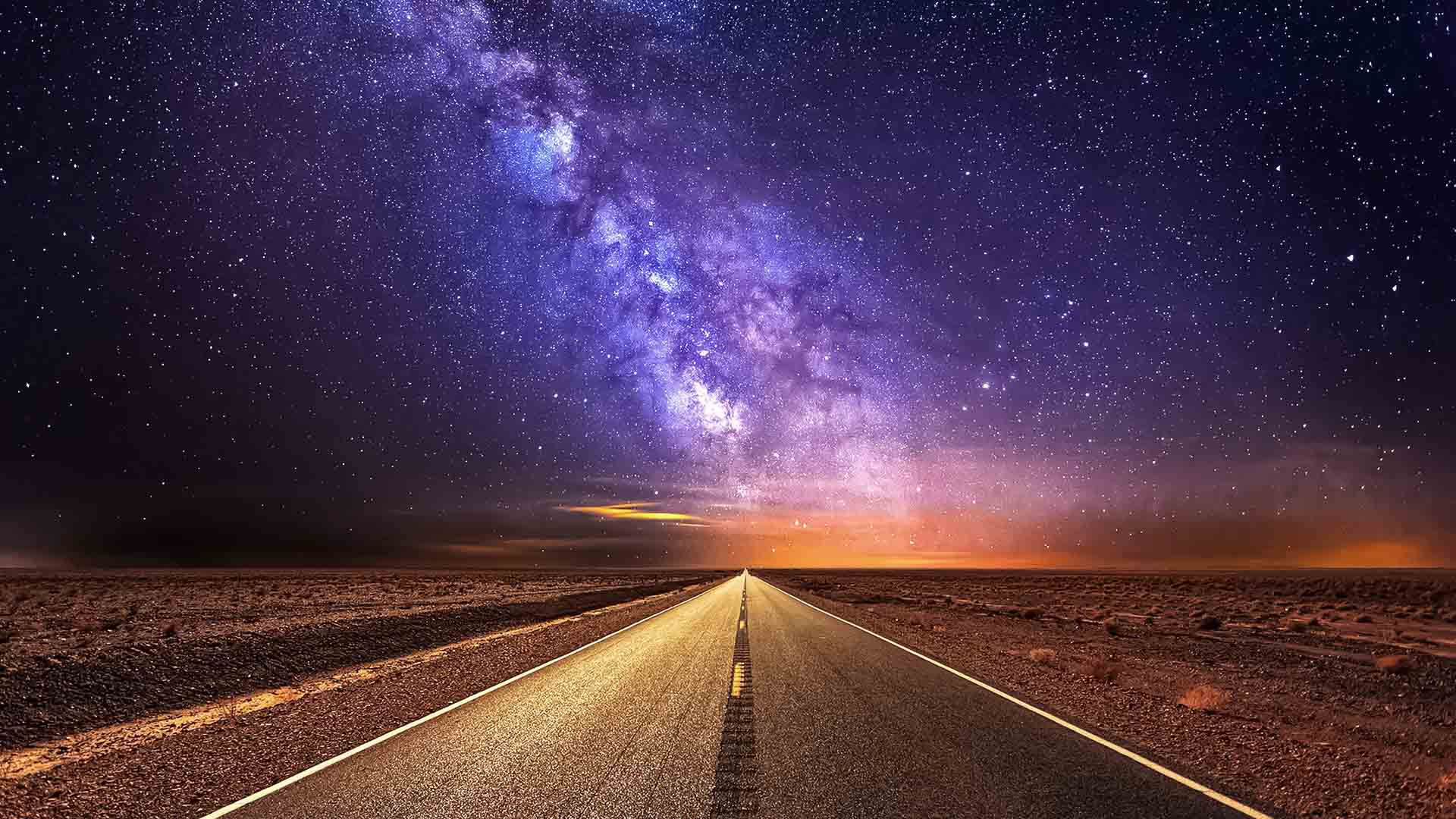 Road in the desert and the purple milky way